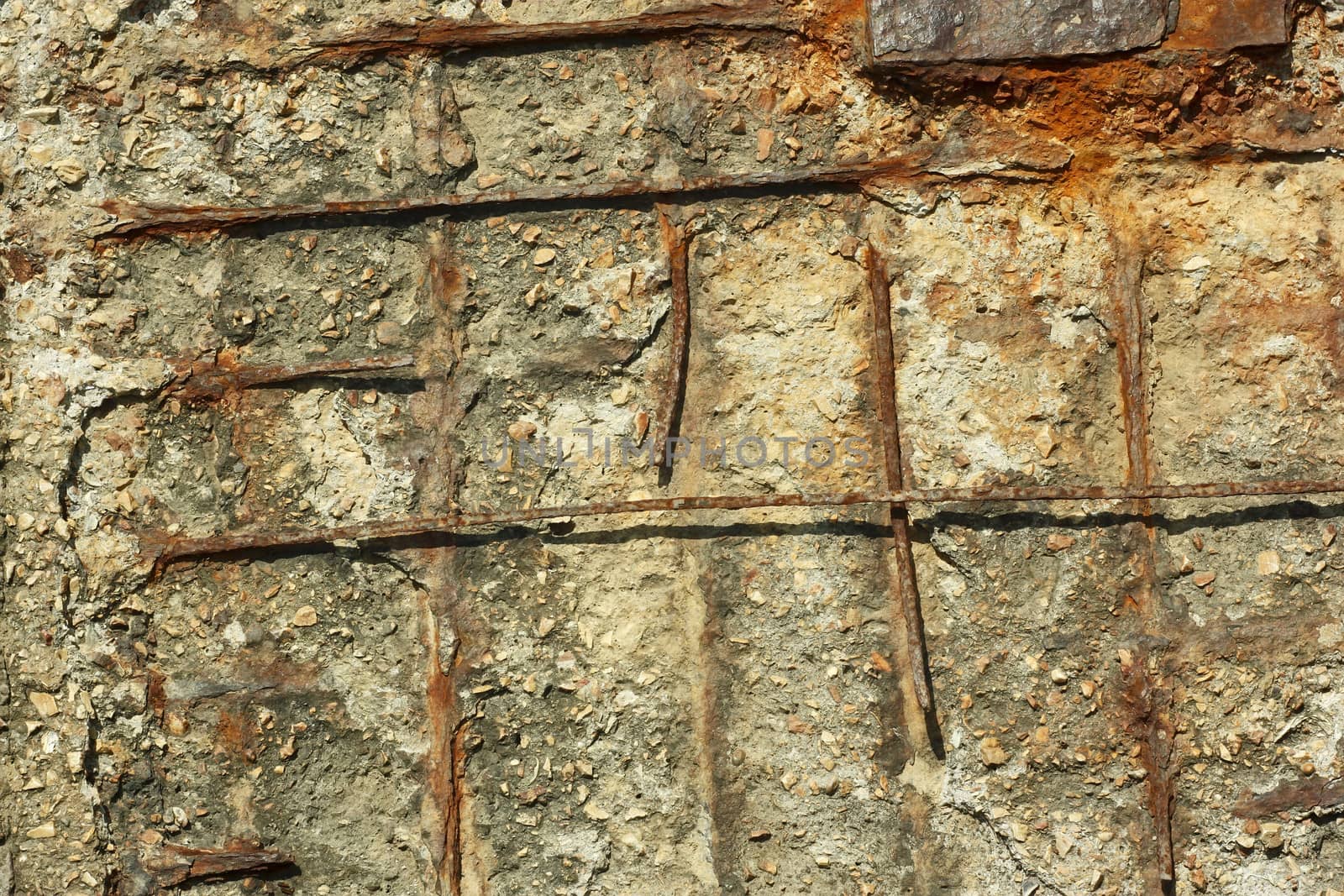 Fragment of old obsolete reinforced concrete structures with rusty iron rods outside