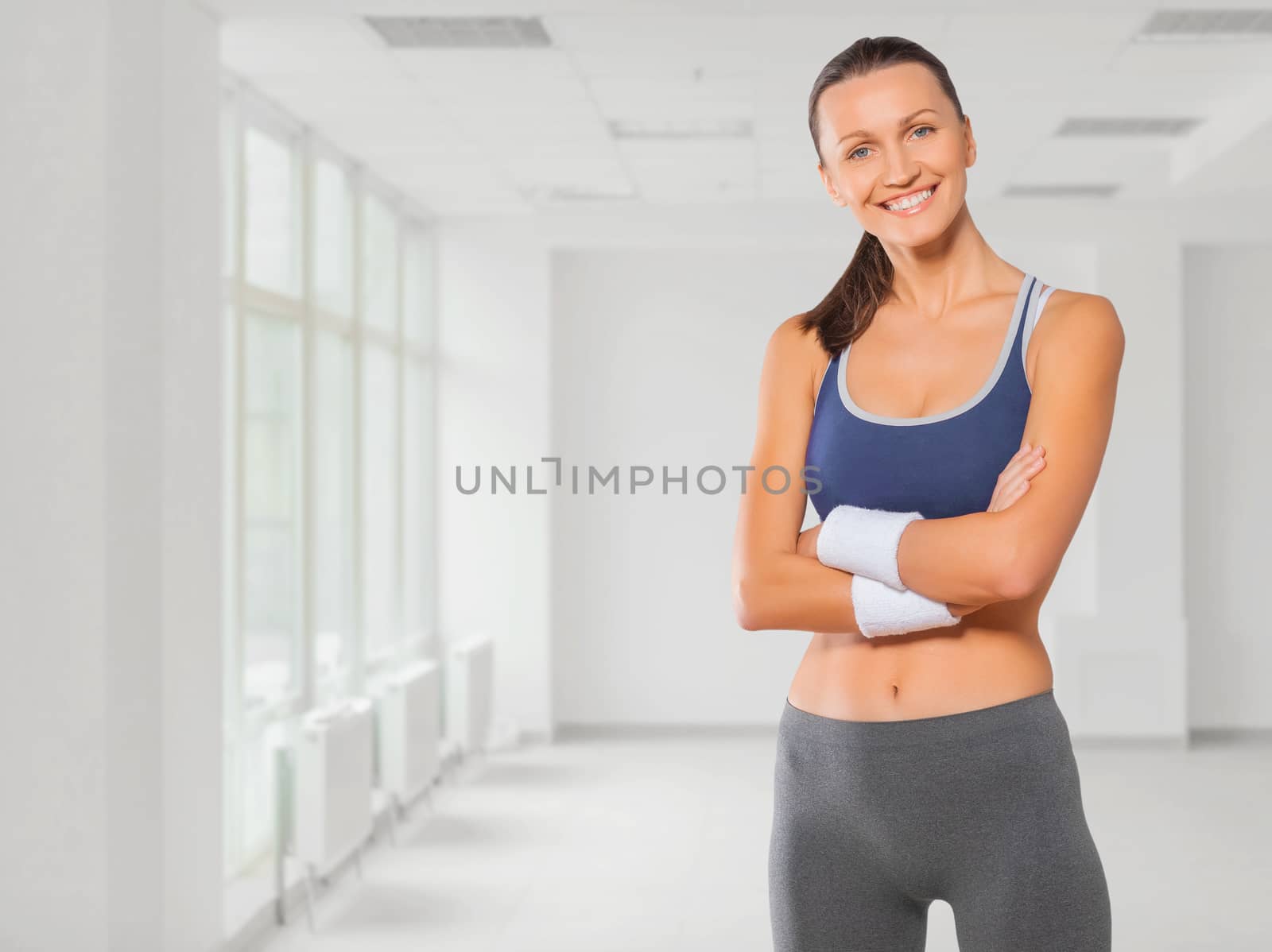 beautiful fitness girl smiling arms crossed