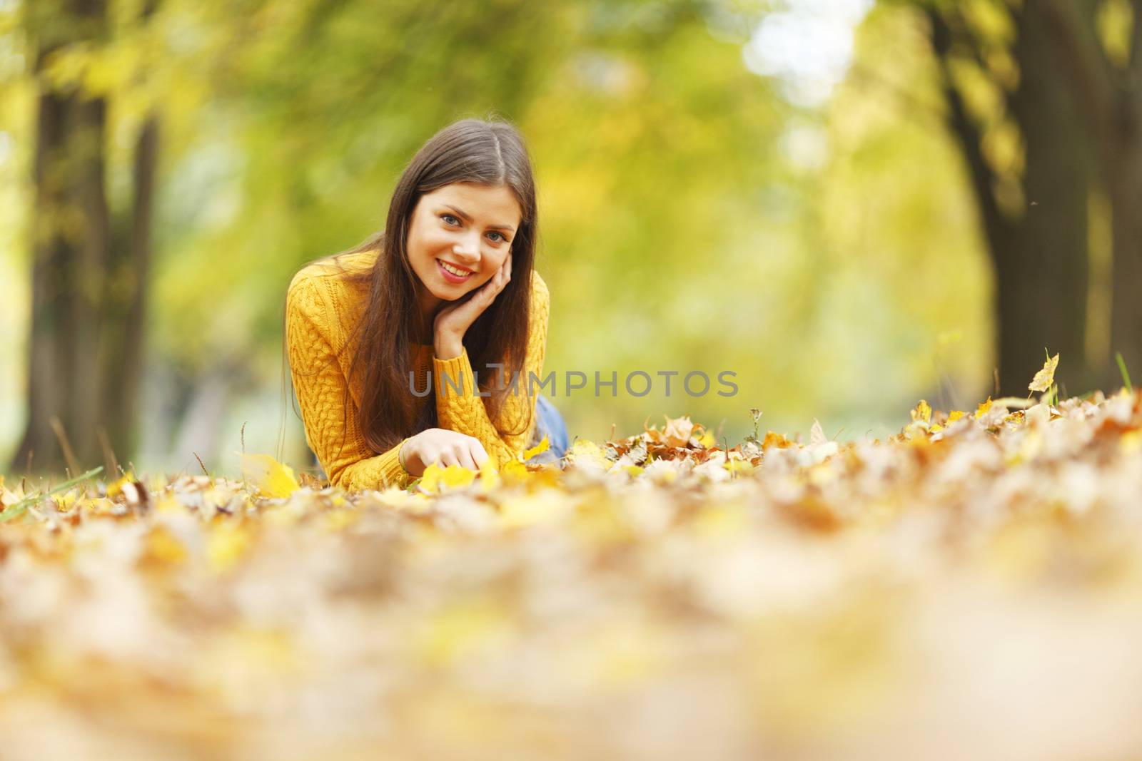 Girl laying on autumn leafs by Yellowj