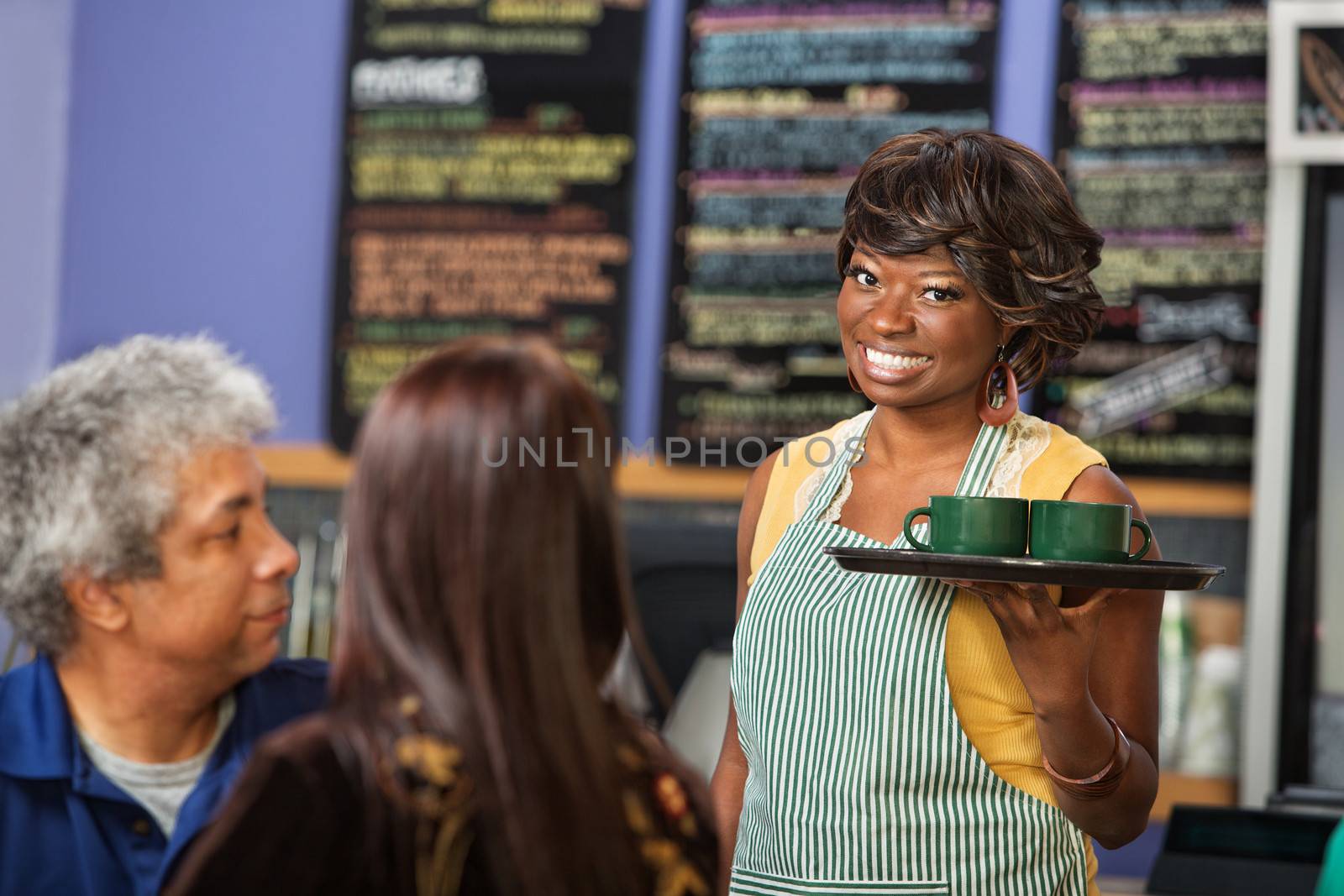 Smiling barista apron working in coffee house