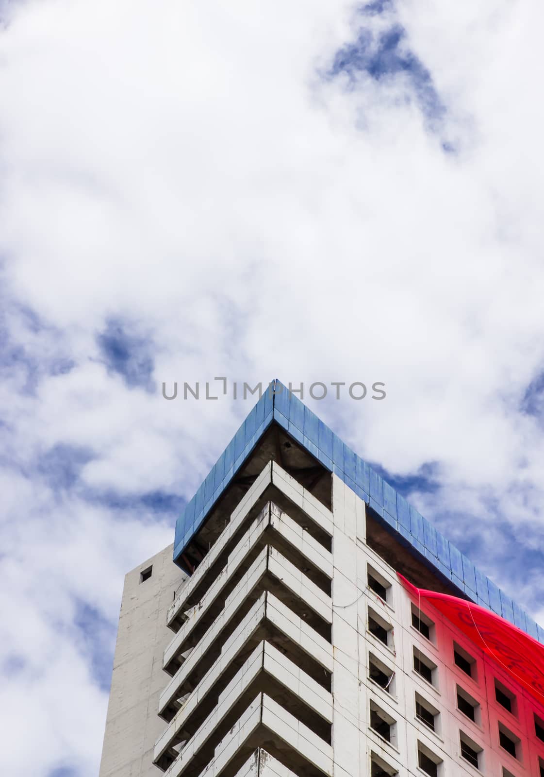 Building triangle and cloudy sky