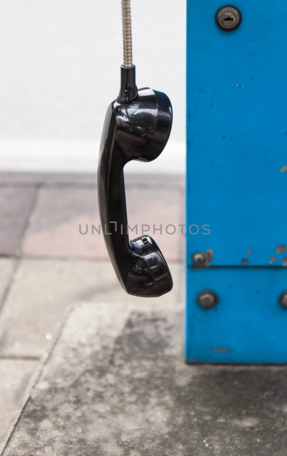 One black handset hanging in a row by photo2life