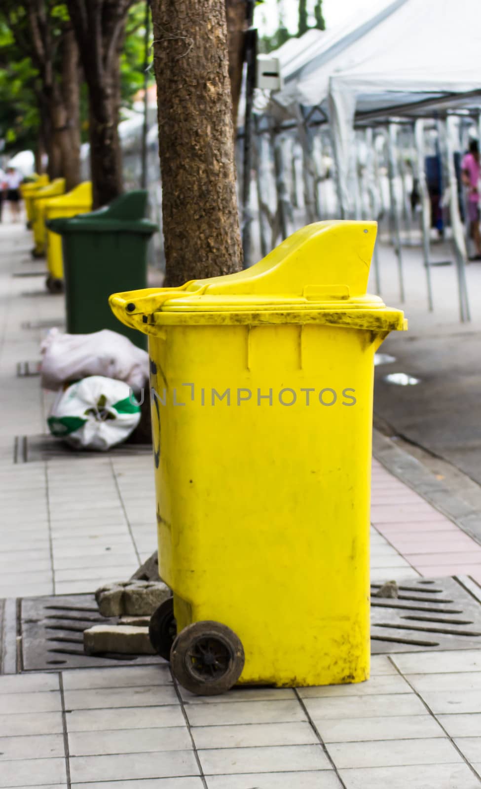 Yellow rubbish bin by photo2life