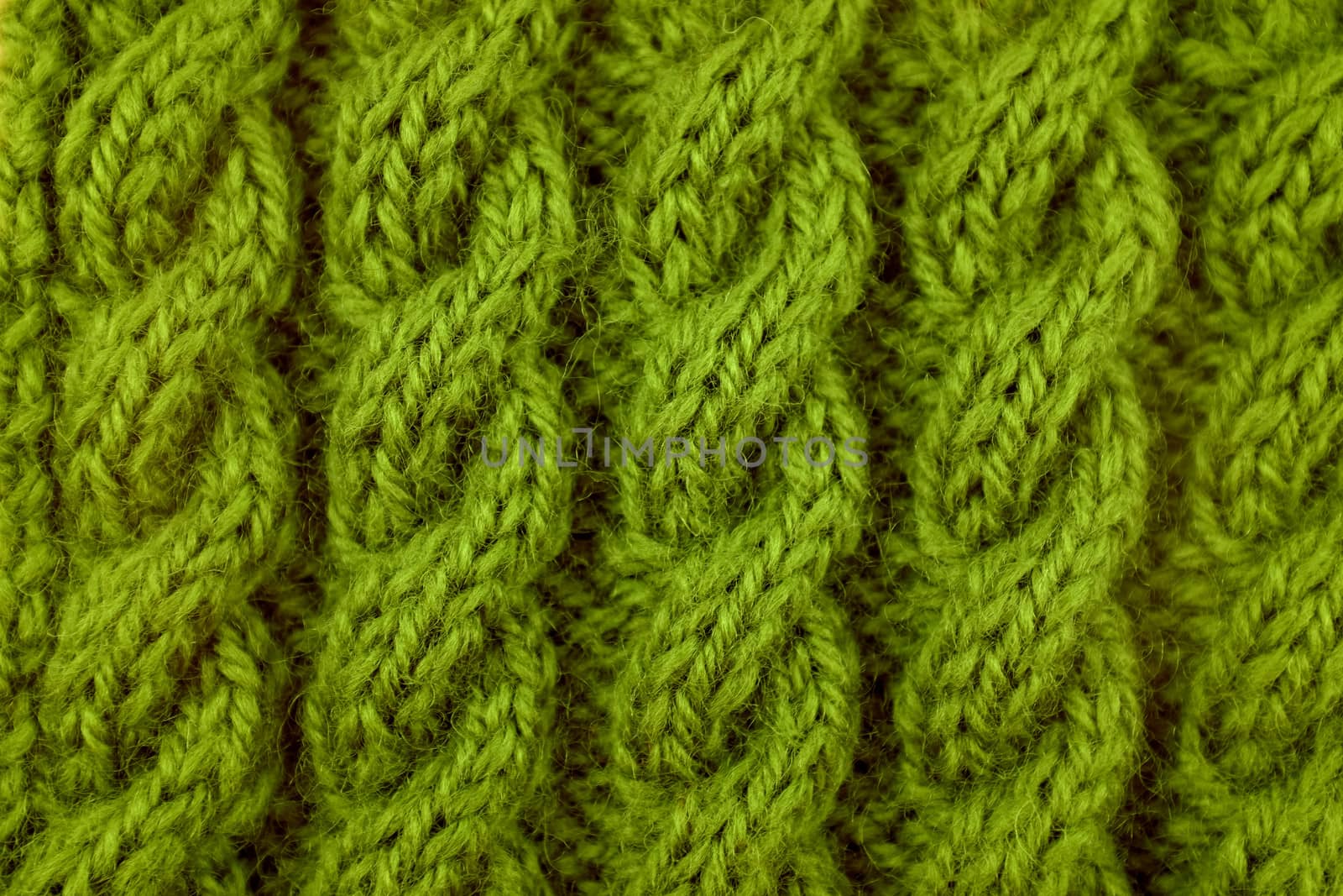Closeup of green coiled rope cable knitting stitch
