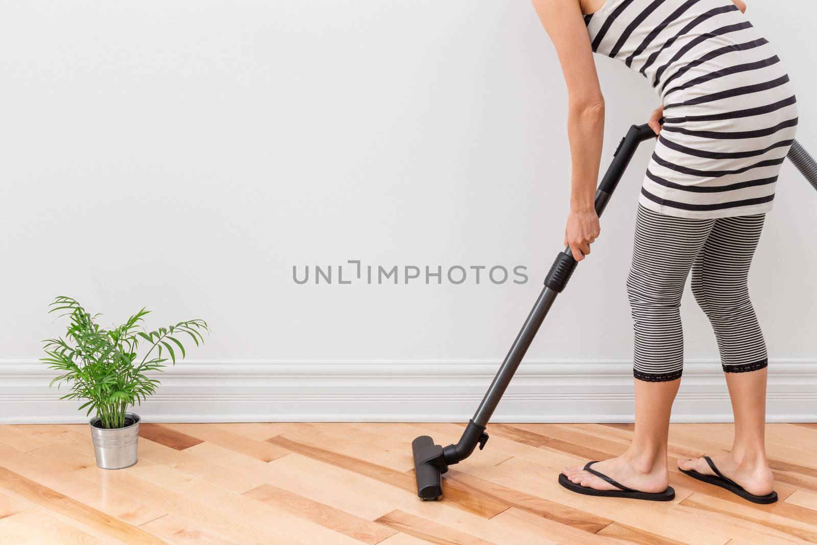 Woman vacuum cleaning the room by anikasalsera