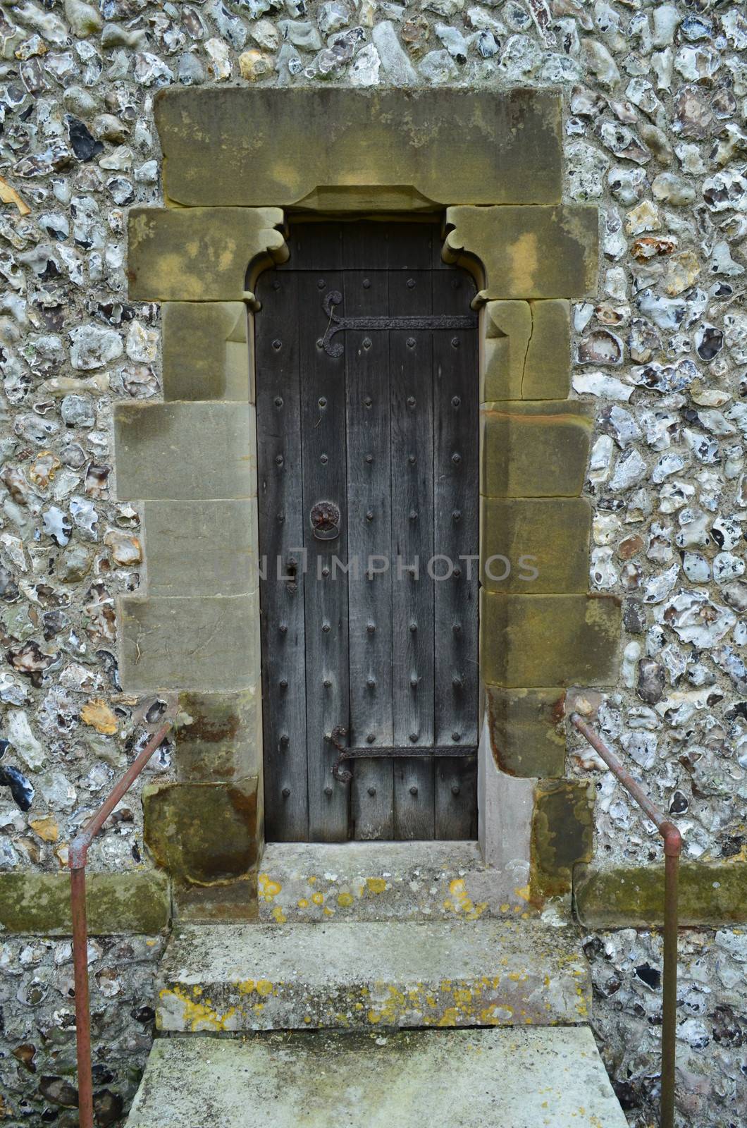 Narrow solid oak door on the church of St Margaret's in the small historic village of Ditchling in the County of Sussex,England.