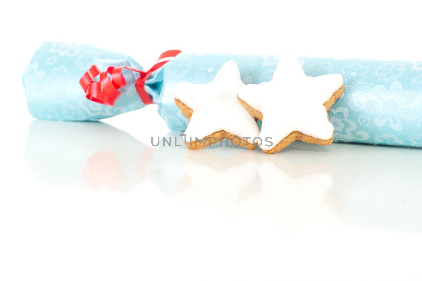 Blue gift with star shaped cinnamon biscuit