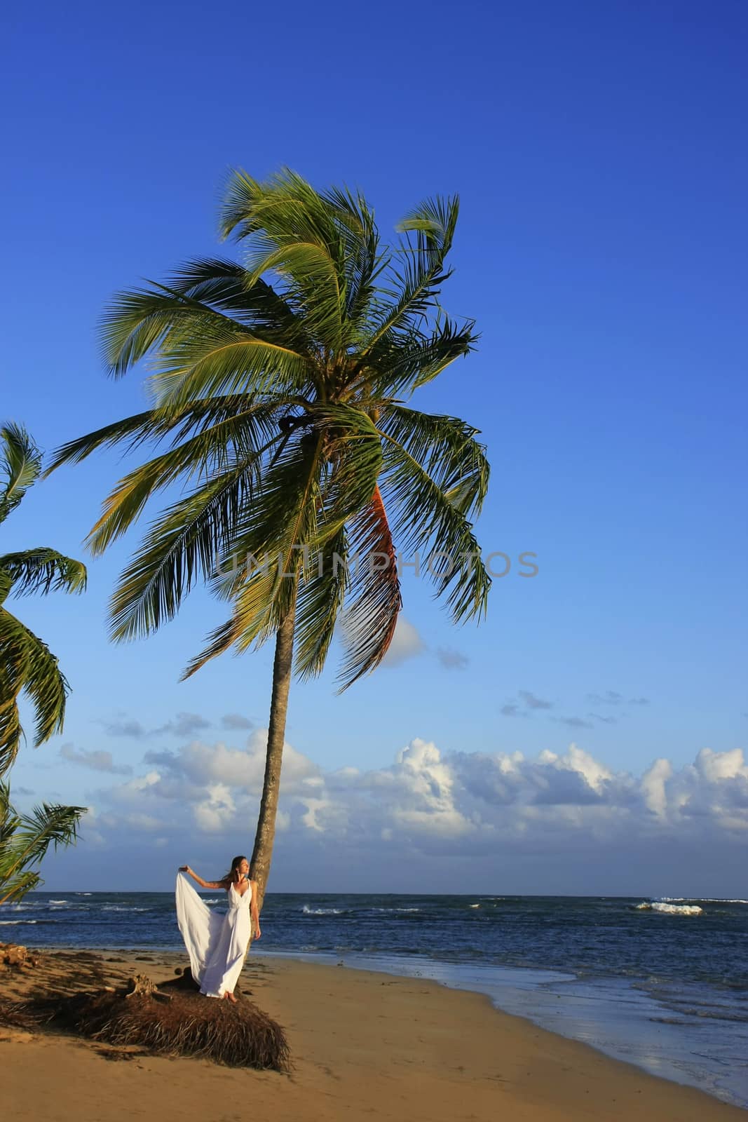 Young woman in white dress on a beach by donya_nedomam