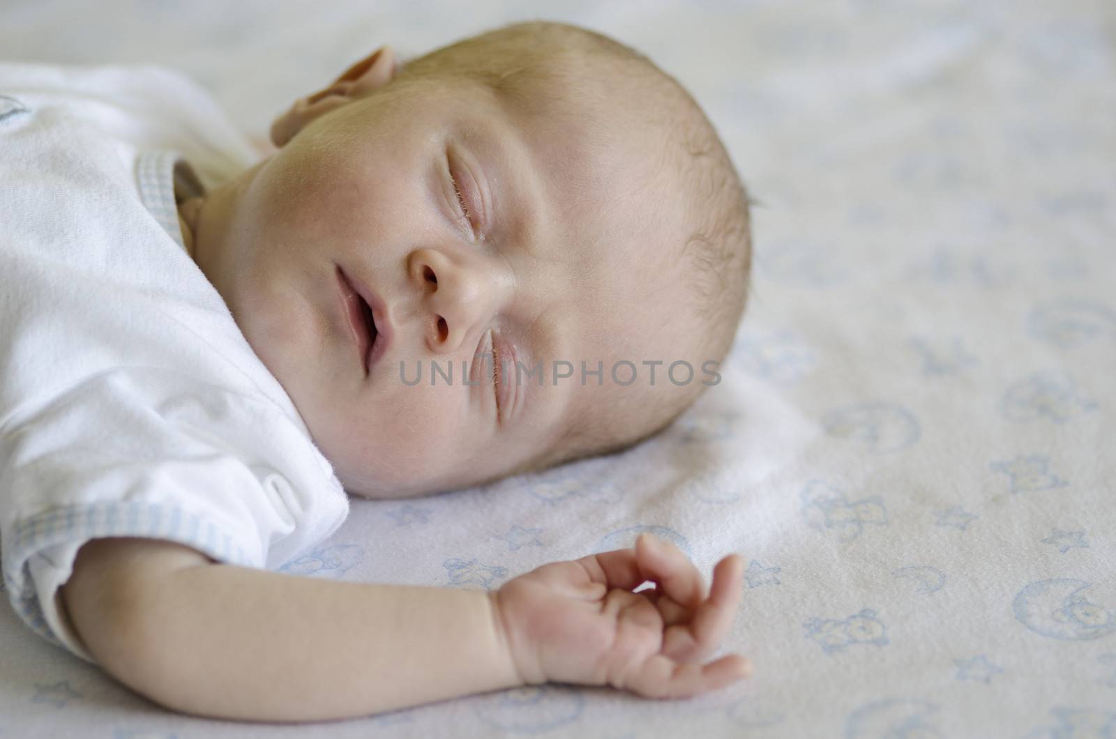 Face of a ute baby sleeping on its back and dreaming