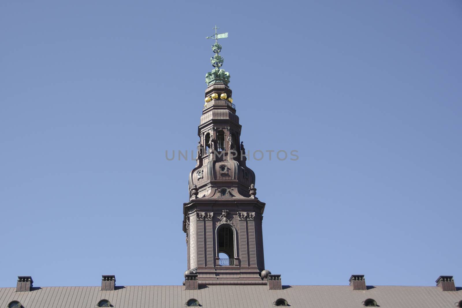 Tower of Christiansborg Palace in Copenhagen in front of a blue sky