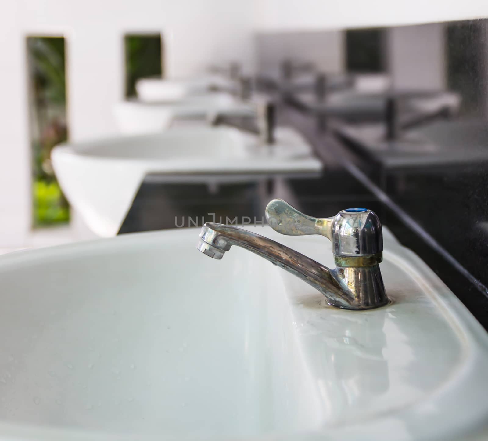 Faucet close up at public toilets.