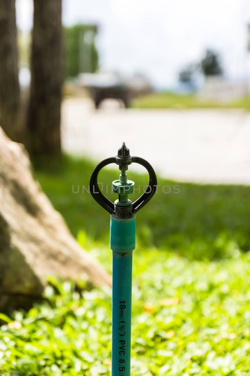 sprinkler water on gardens background by photo2life