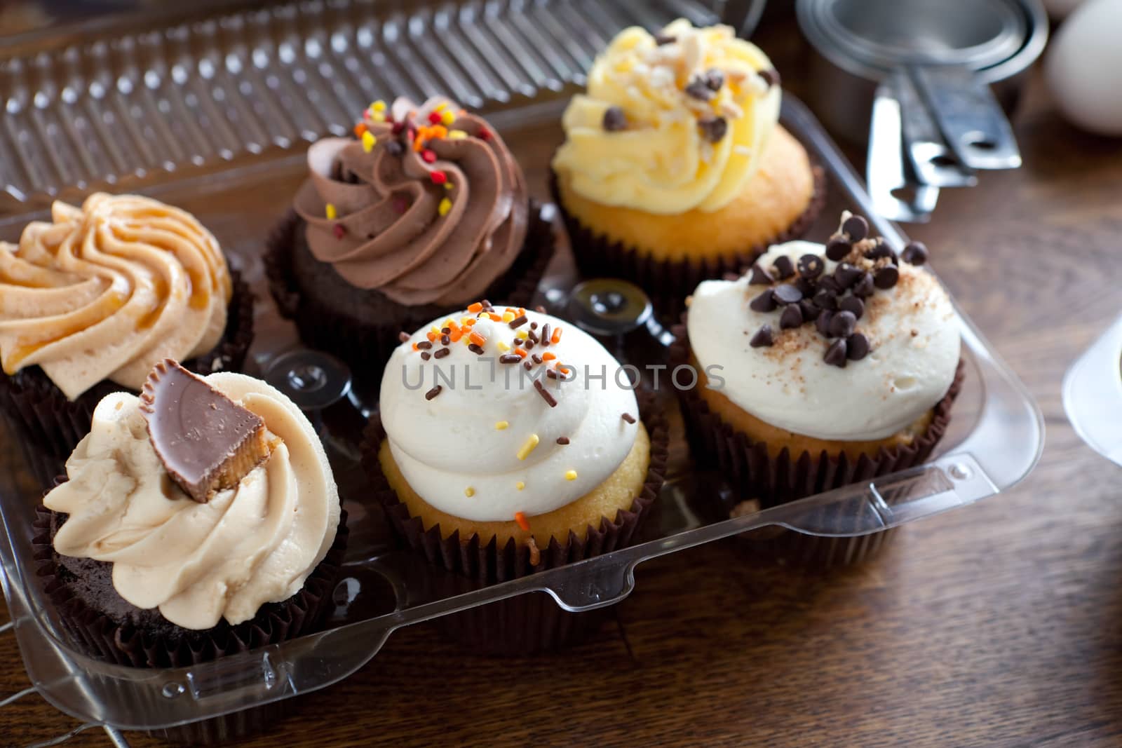 Close up of some decadent gourmet cupcakes frosted with a variety of frosting flavors. Shallow depth of field.