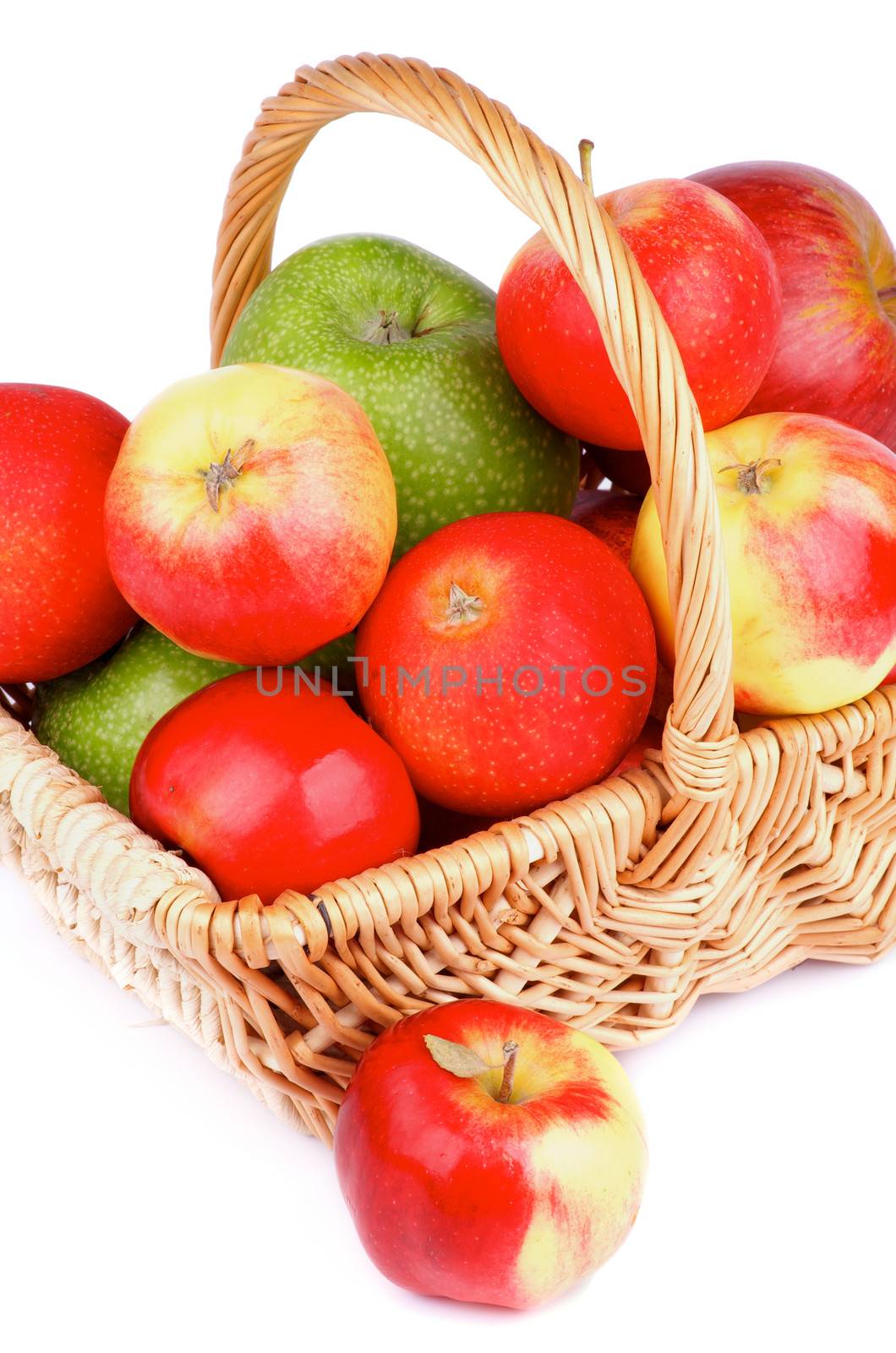 Arrangement of Red and Green Apples in Wicker Basket isolated on white background