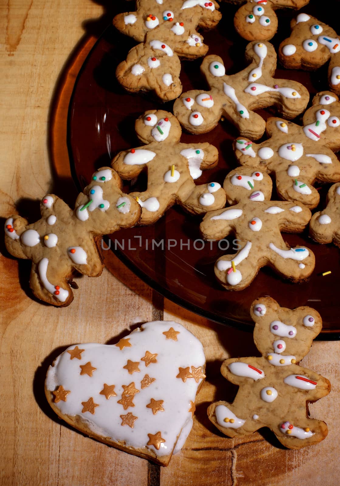 Arrangement of Christmas Gingerbread Men, Bears and Heart with Decorated Icing on Wooden background