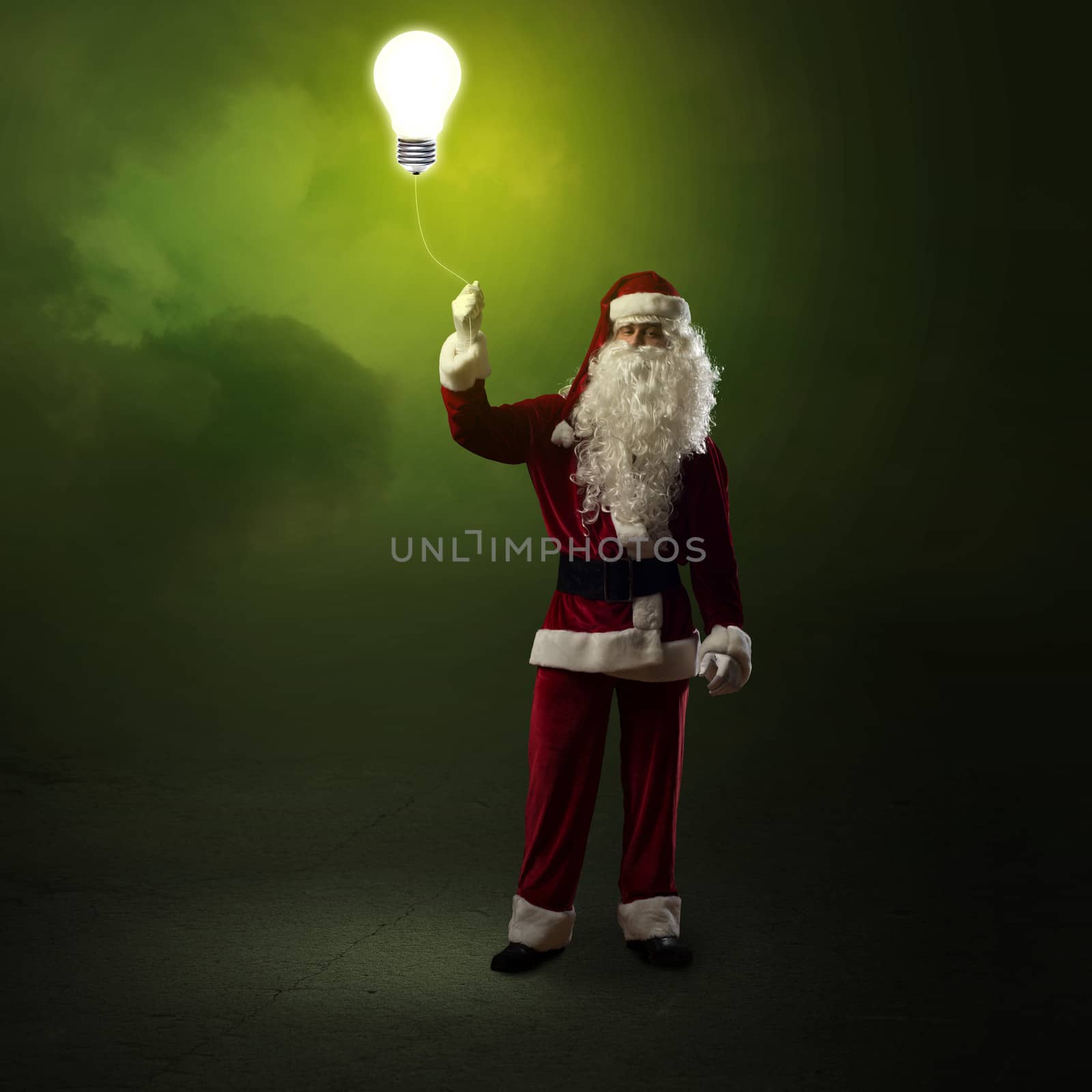 Santa Claus is holding a shining lamp by adam121