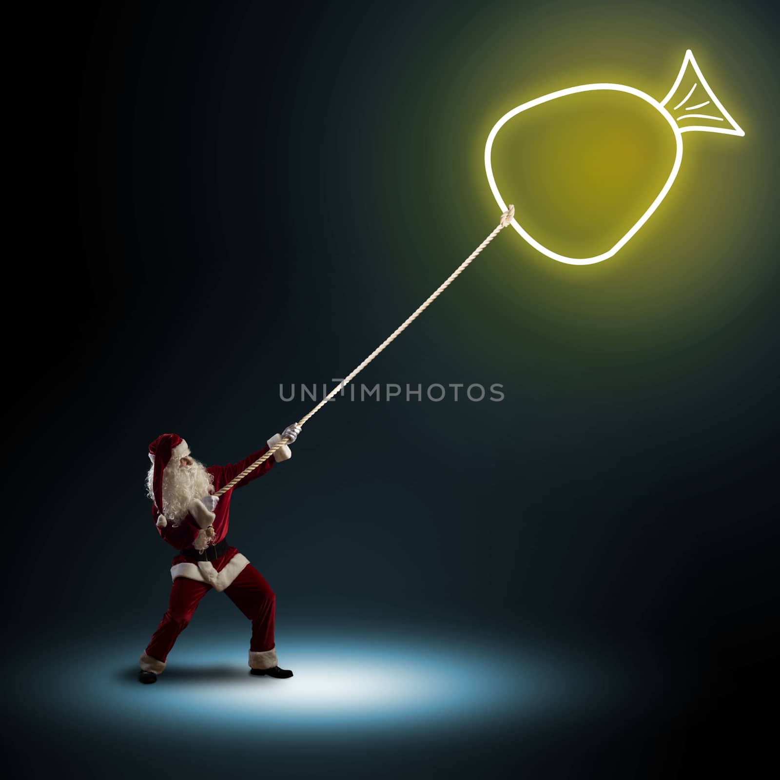 Santa Claus pulls a rope with a symbol bag with a gifts