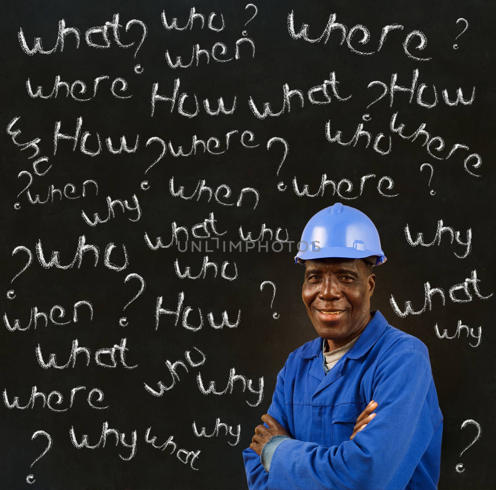 African American black man worker with chalk questions on a blackboard background