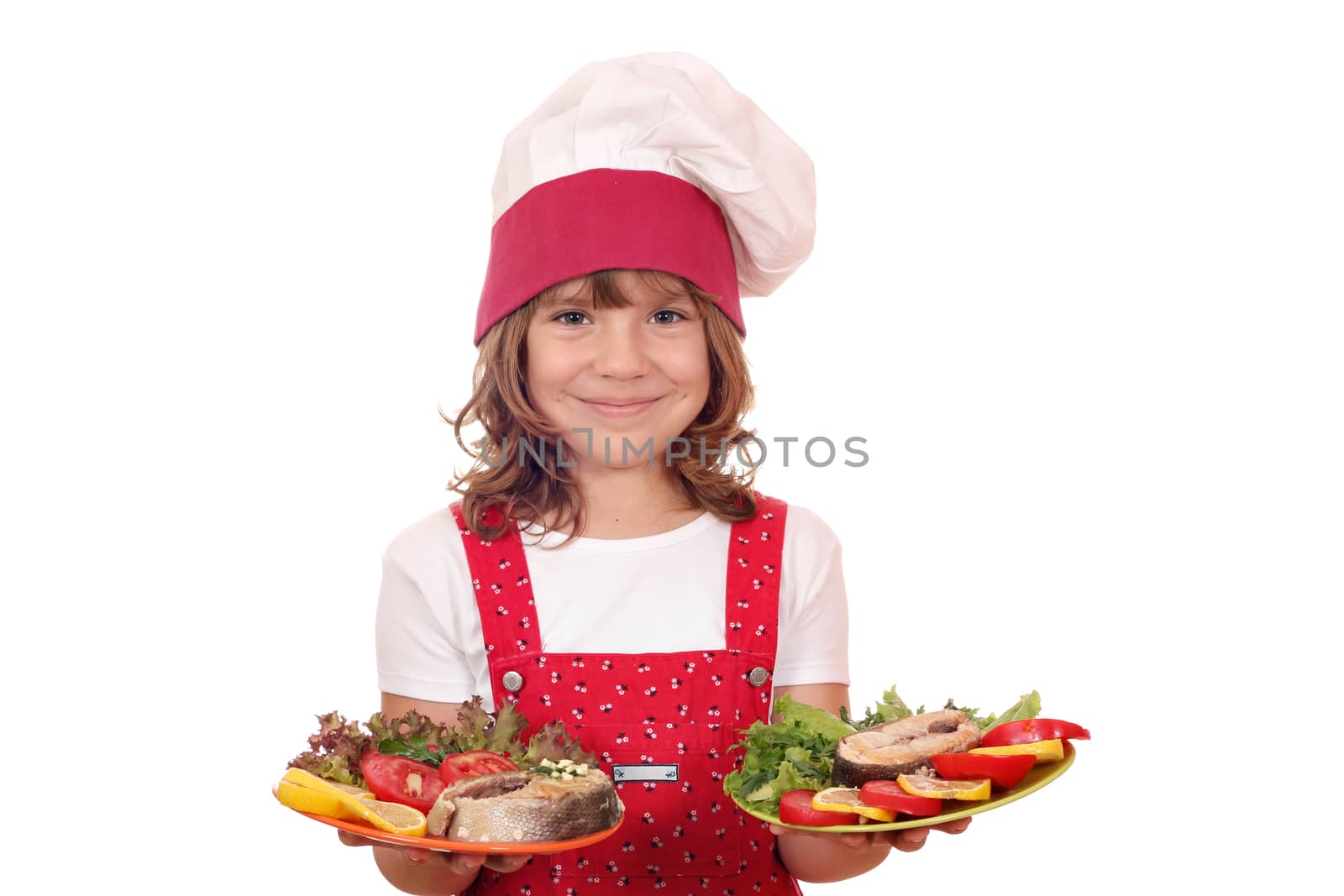 happy little girl cook holding plate with salmon seafood by goce