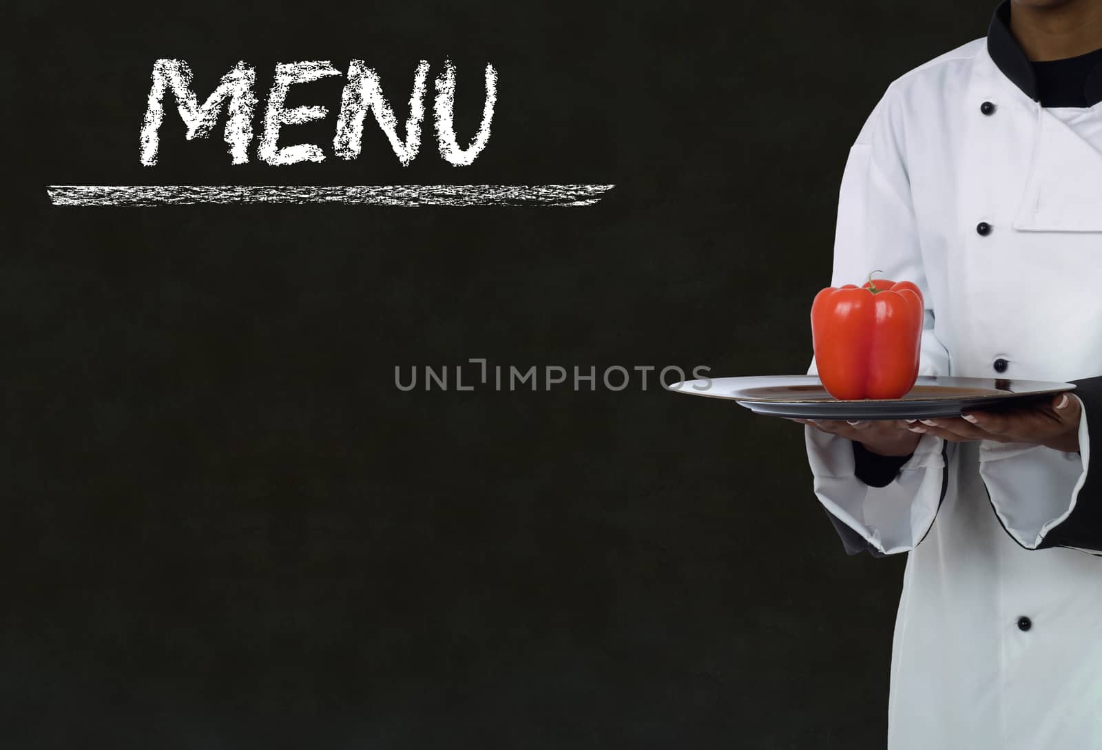 Chef with chalk menu sign written on blackboard background