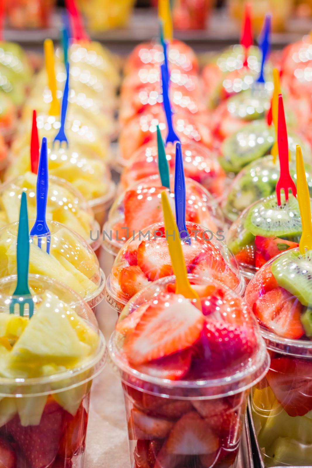 Set packed slice of fresh fruits in the famous La Boqueria market, Ramblas street, Barcelona, Spain