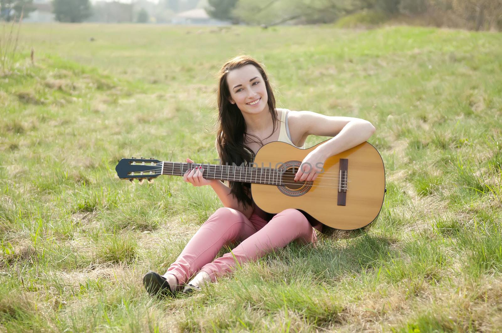 pretty young woman playing guitar