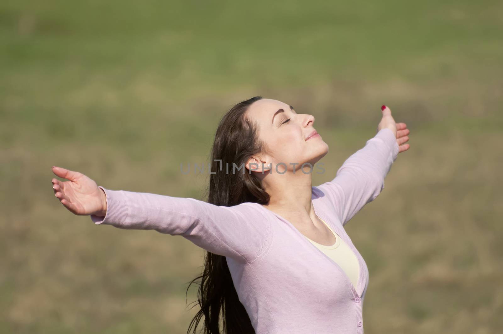 young woman feeling free with arms wide open