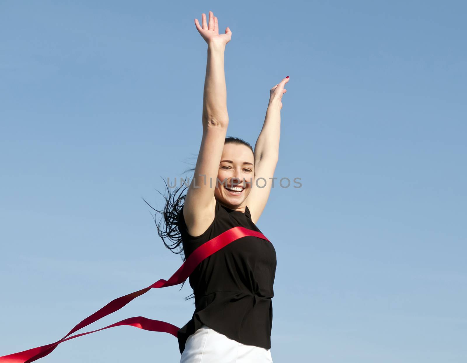 woman crossing finishing line