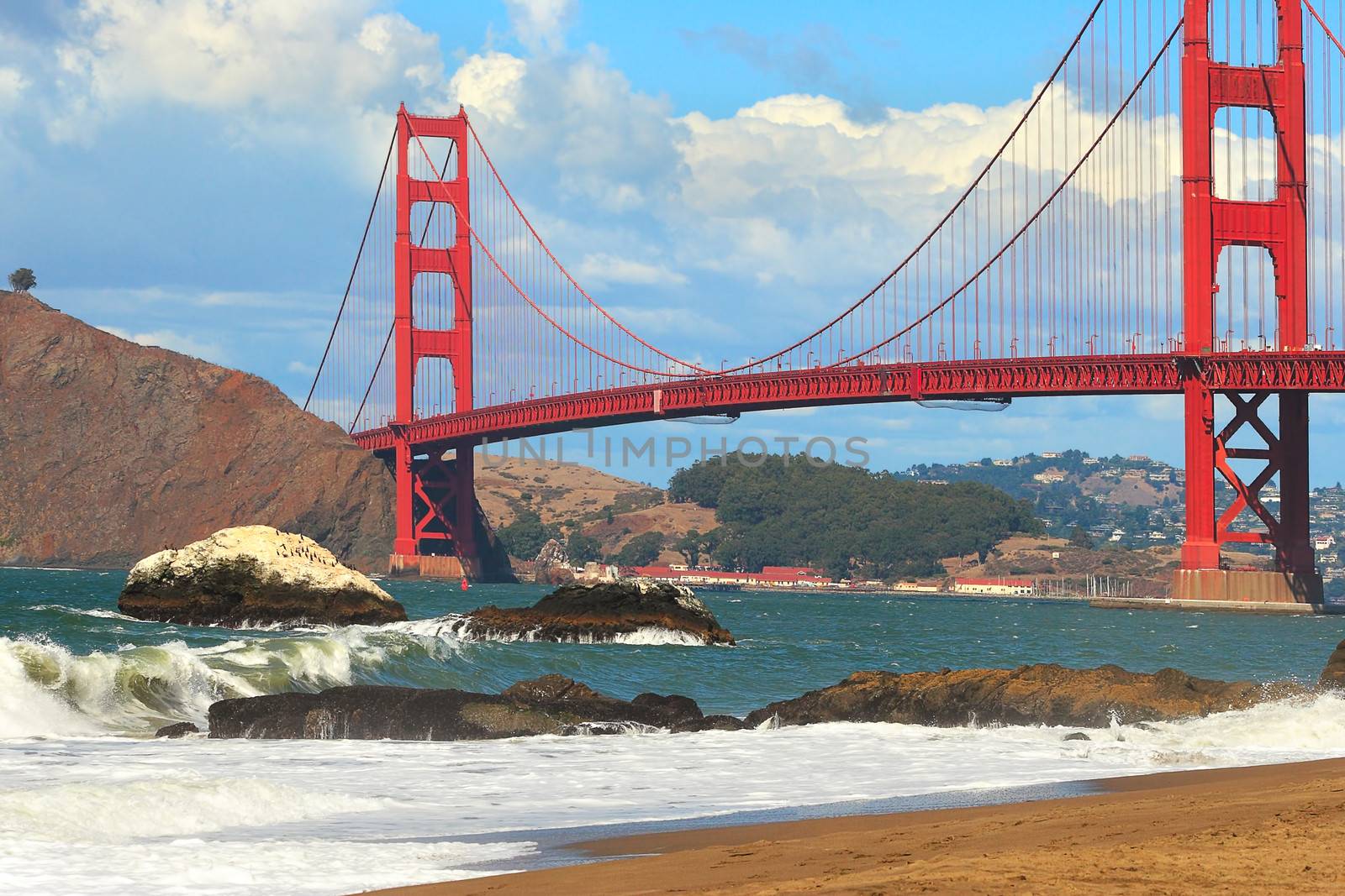 View of famous red Golden Gate Bridge as seen from Baker beach in San Francisco, USA.