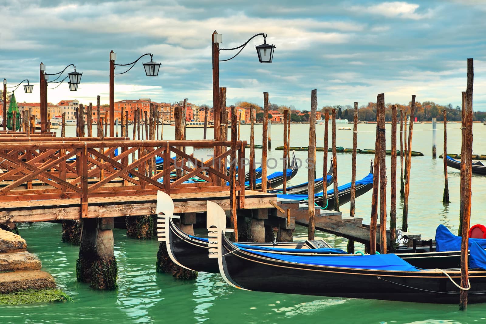 Gondolas moored in row on Grand canal in Venice. by rglinsky