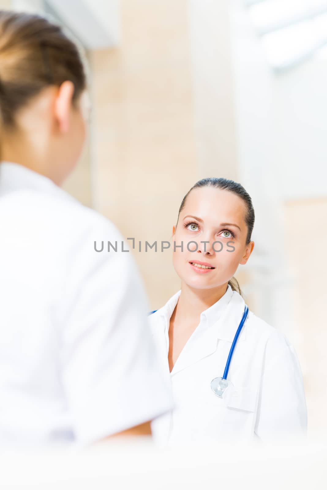 two doctors talking in the lobby of the hospital,