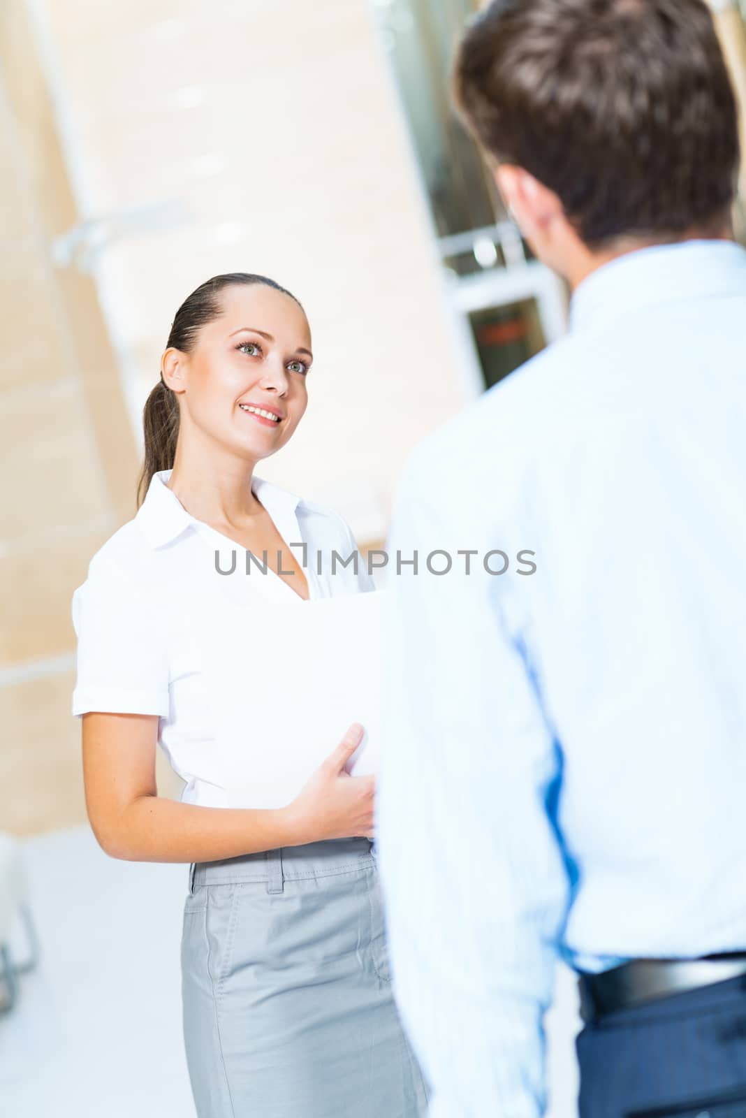 Business woman talking with a colleague in the office