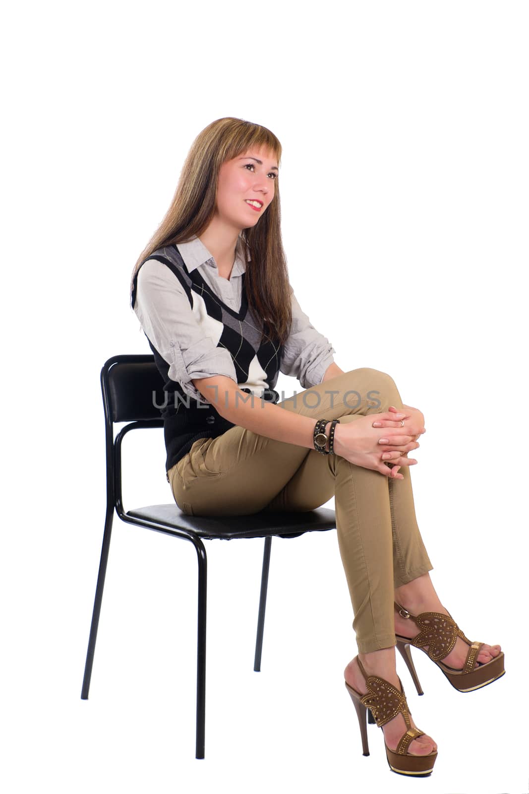girl in a chair holding his hands over his knee