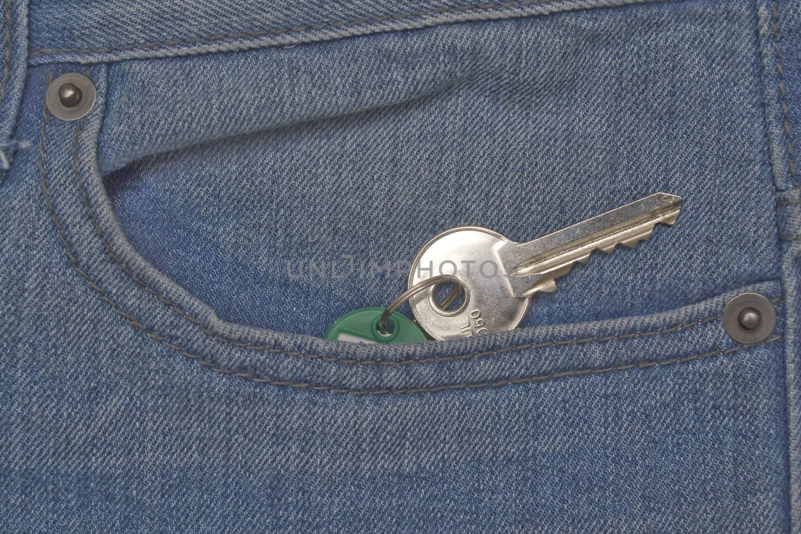 Denim jeans pocket with house key hanging out
