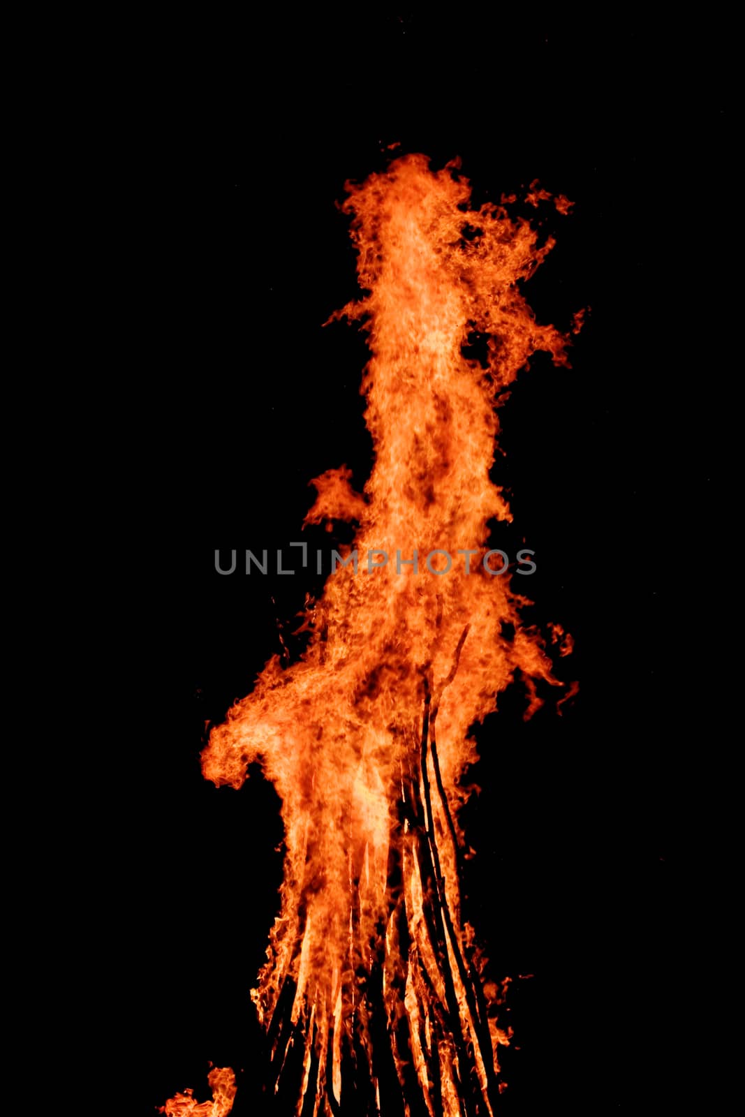 red flames of huge bonfire or campfire as black backgorund