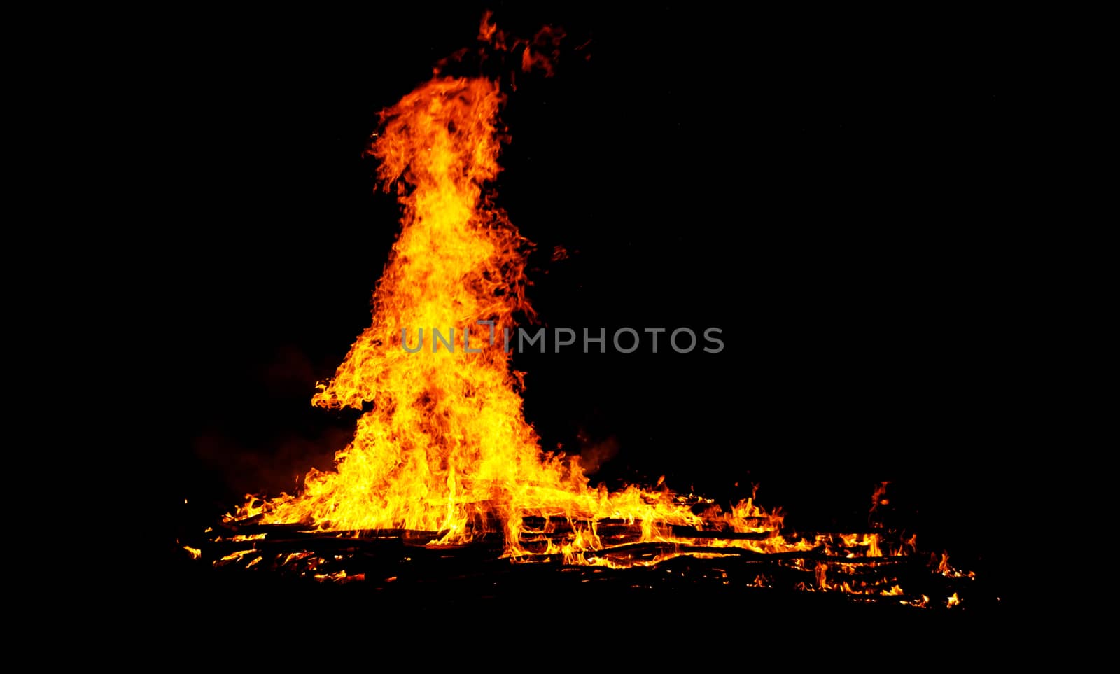 red flames of huge bonfire or campfire as black backgorund