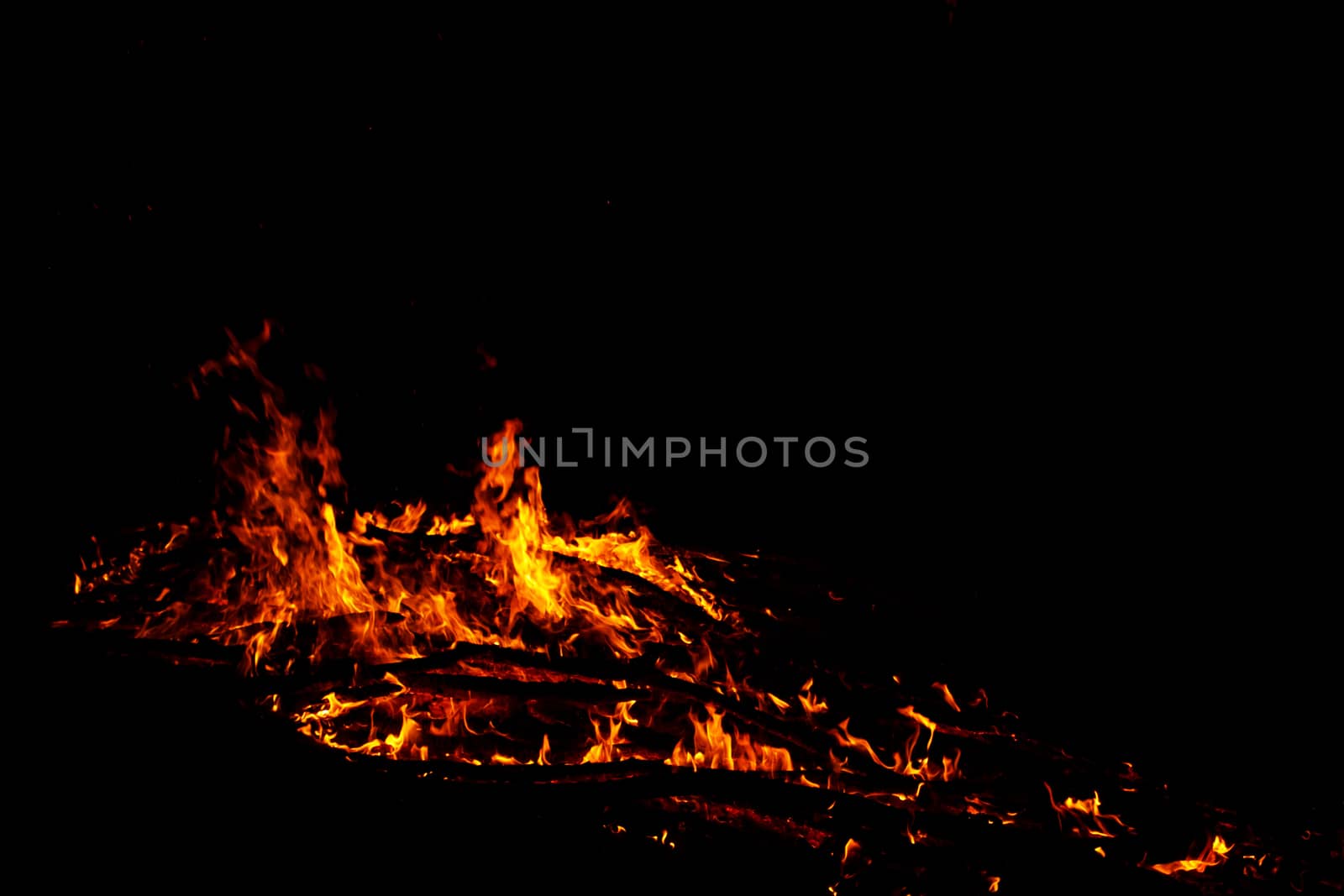 red flames of huge bonfire or campfire as black backgorund