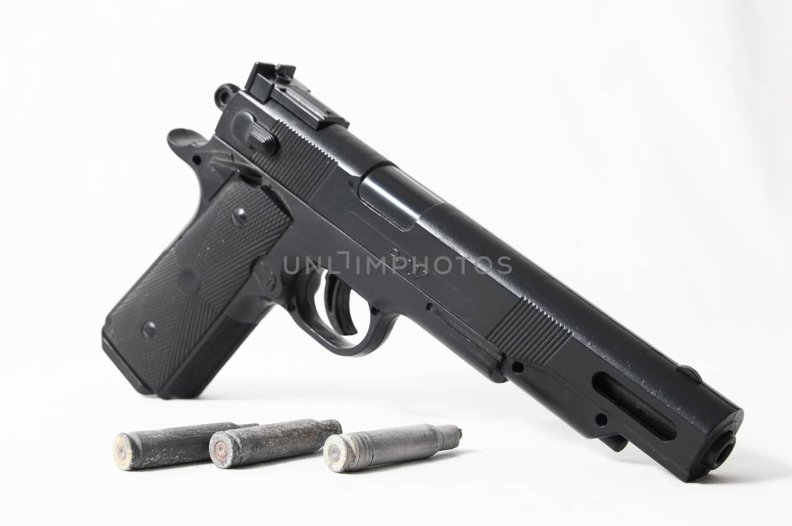 Pistol Gun and Bullets on a White Background
