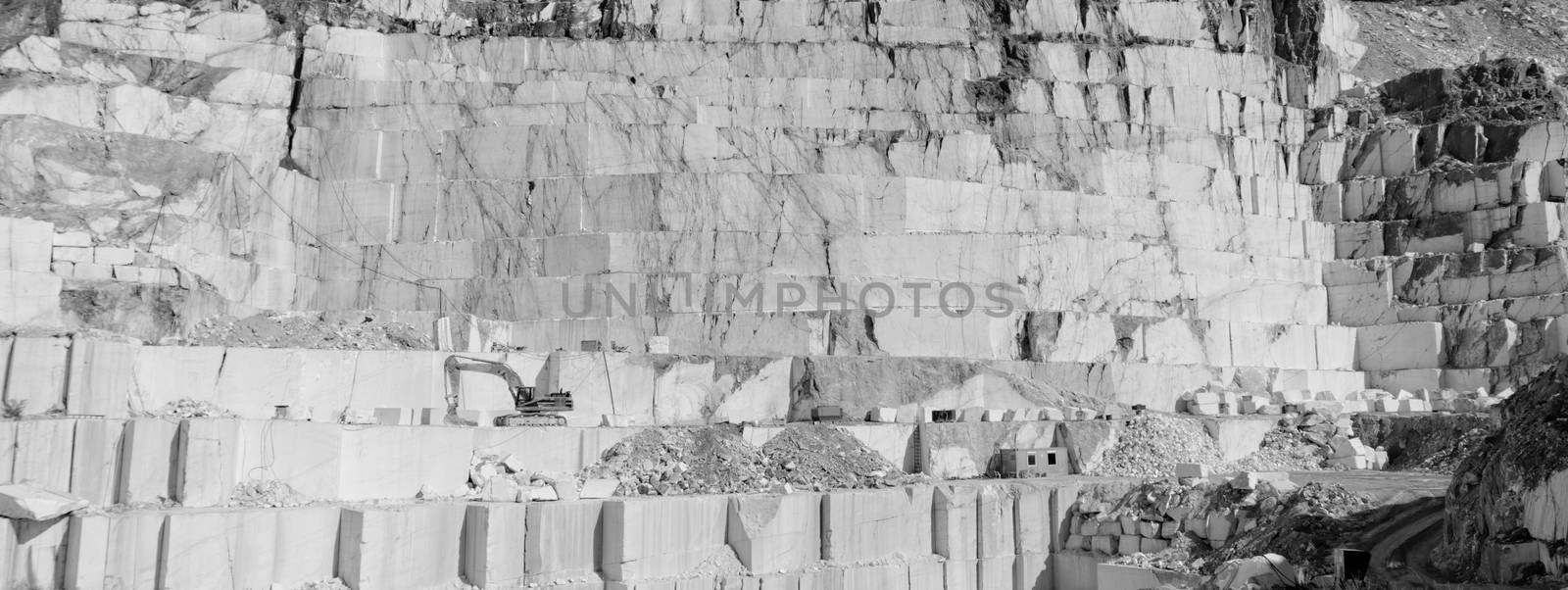 Detail of huge Thassos white marble quarry (mine) with grabber in bw color