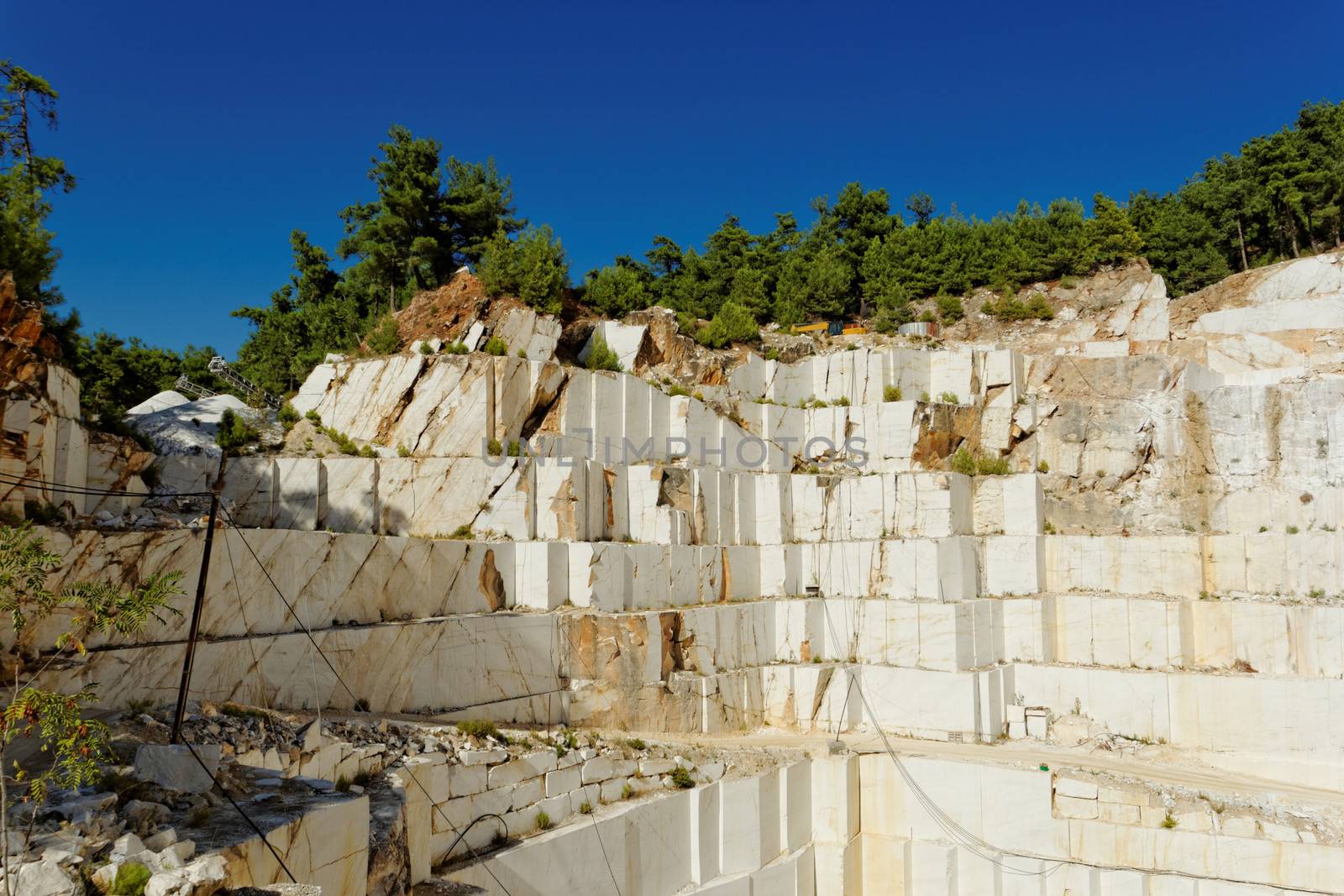 Detail of huge Thassos white marble quarry (mine) with grabber