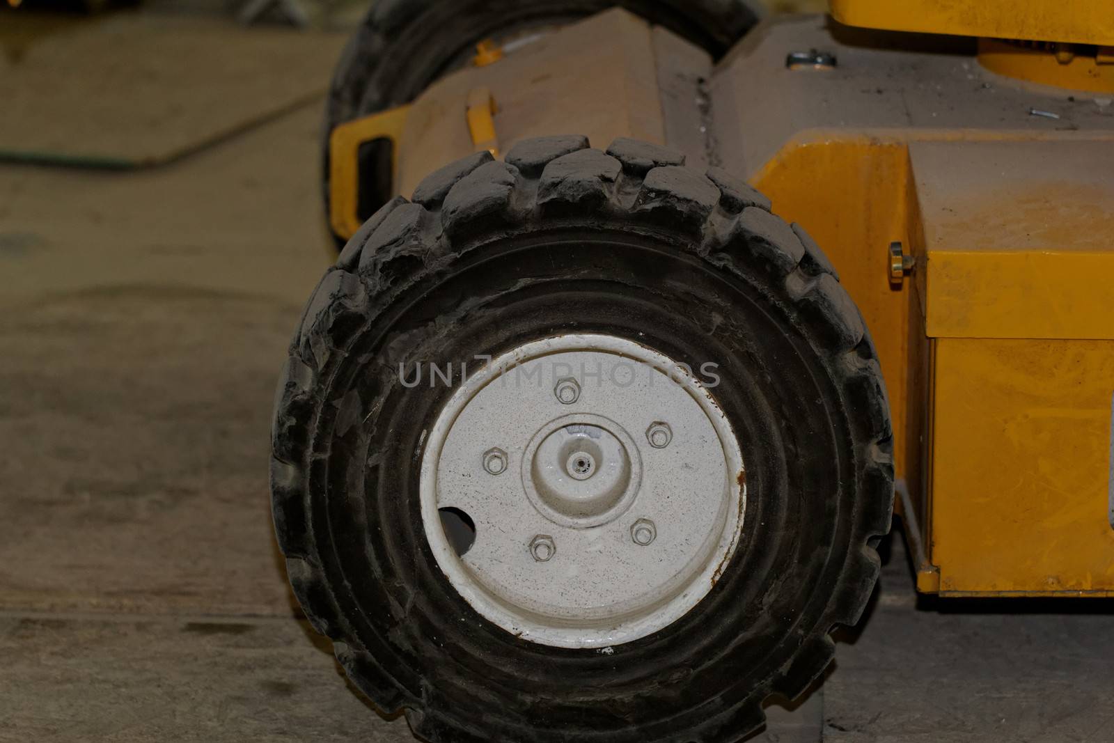 Yellow industrial machine with solid rubber wheel