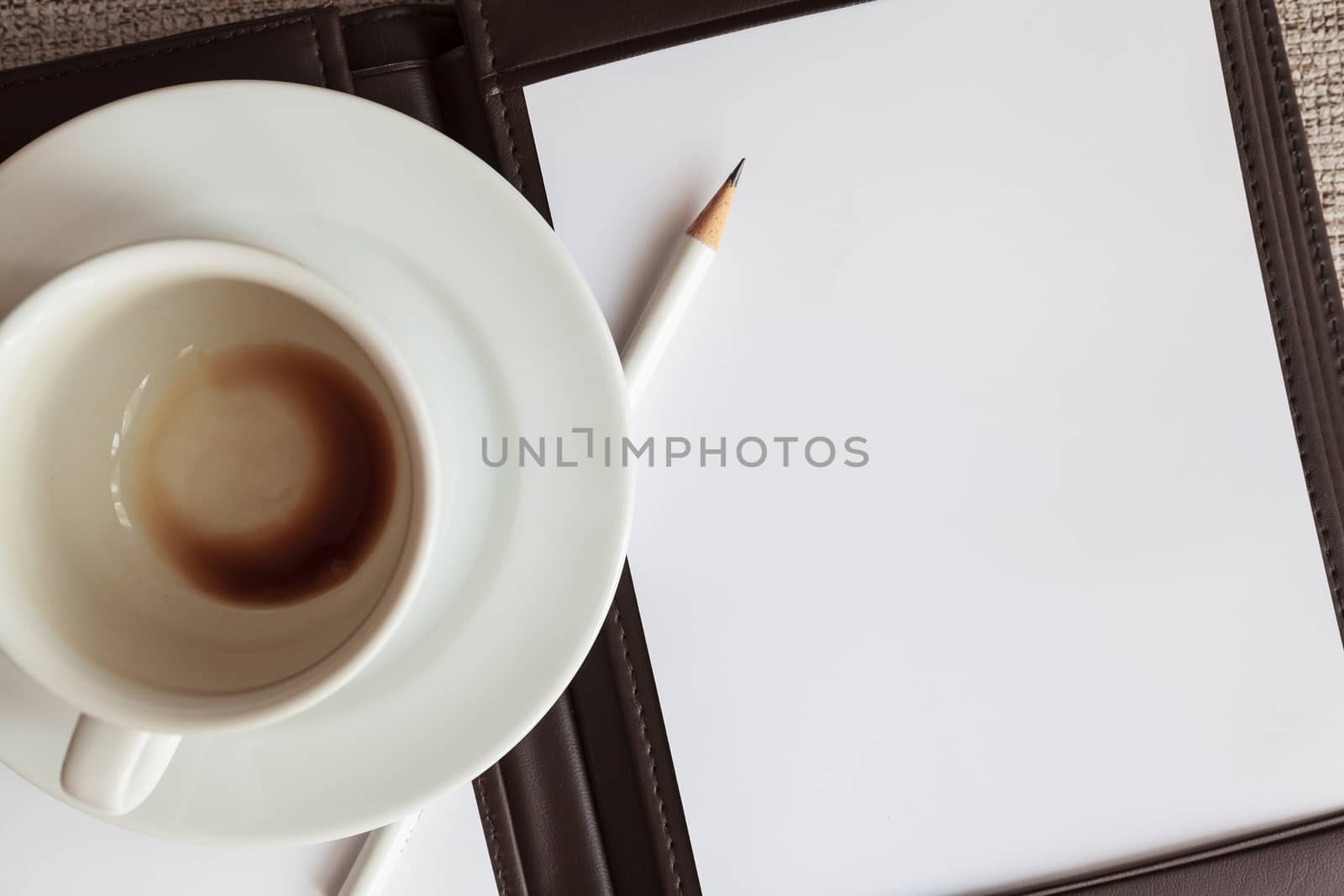 blank white notebook, pencil and empty coffee cup