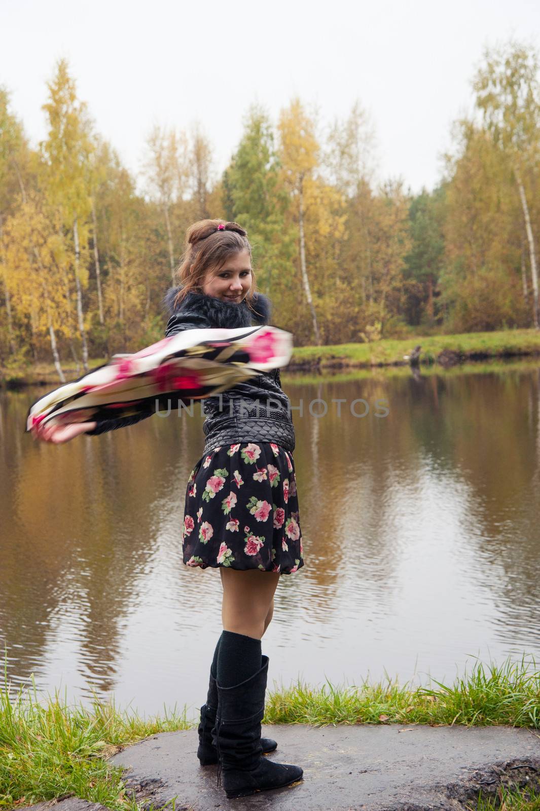 happy woman waving a handkerchief lake