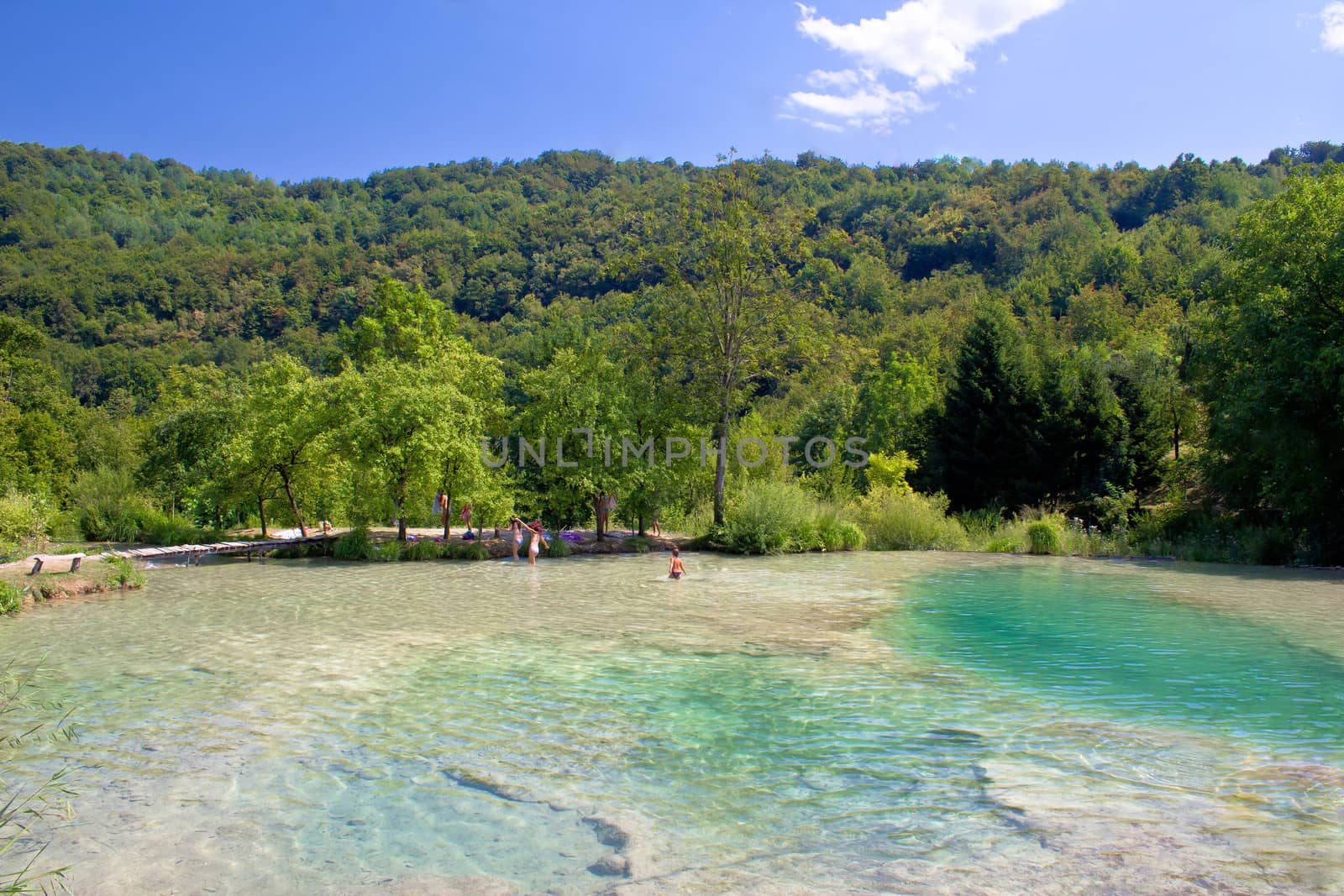 Children enjoying pure waters of Plitvice lakes National park in Croatia