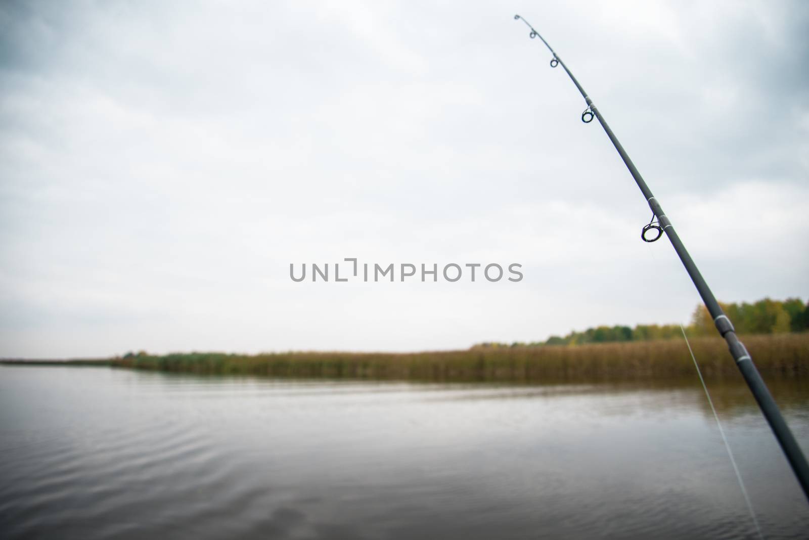 Fishing rod at the calm autumn river