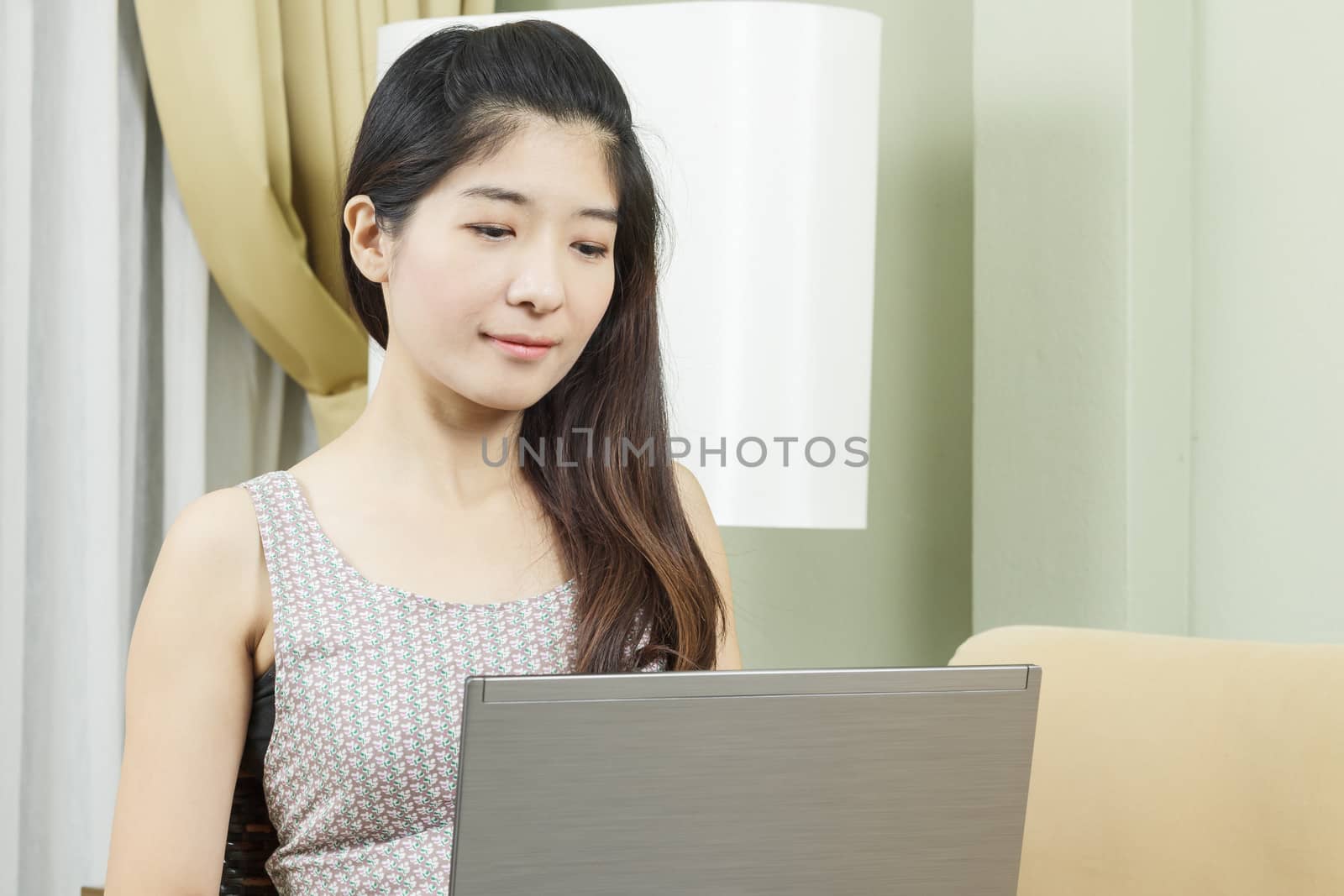 Asian young business woman working on laptop or notebook by FrameAngel