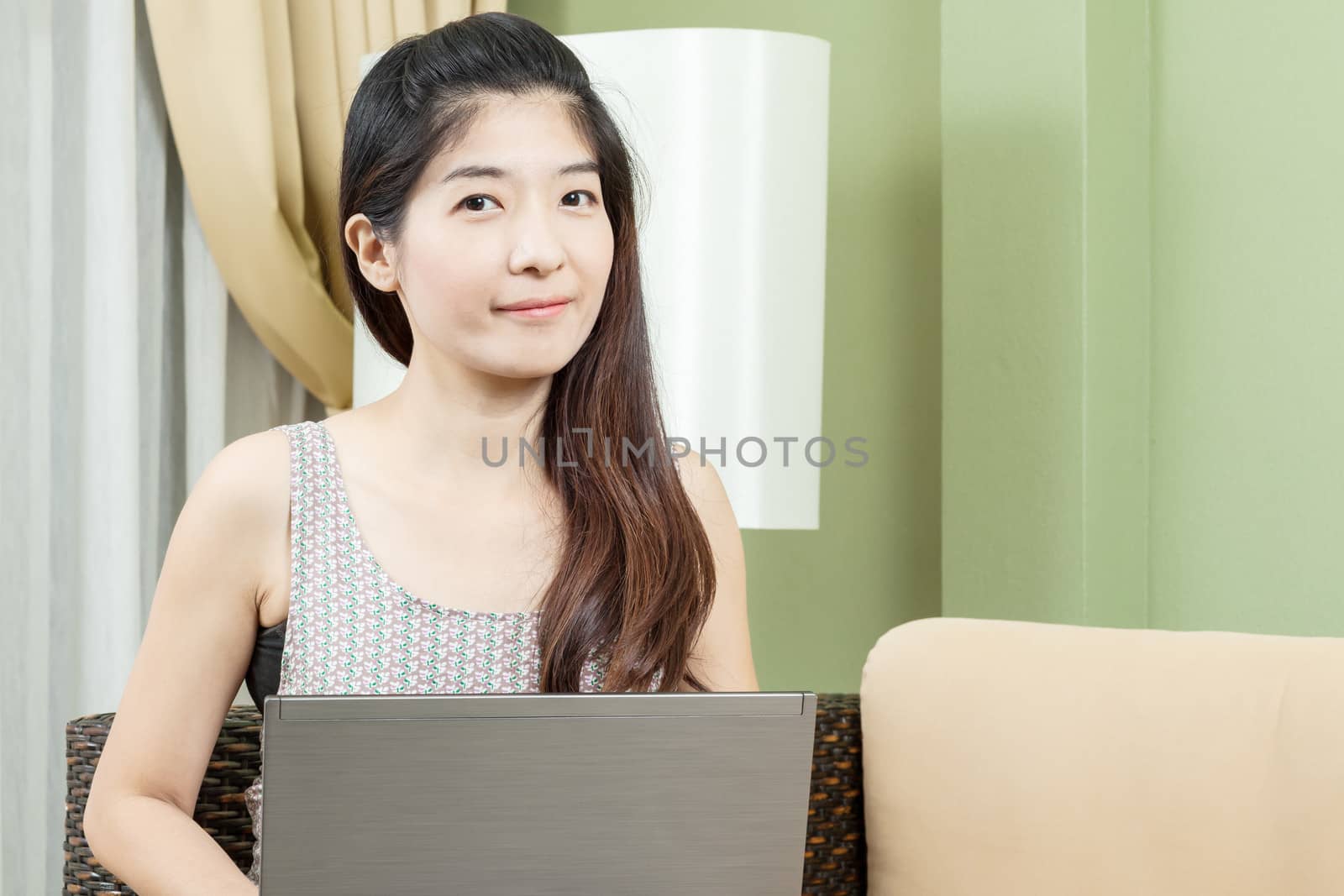 Asian young business woman working on laptop or notebook by FrameAngel