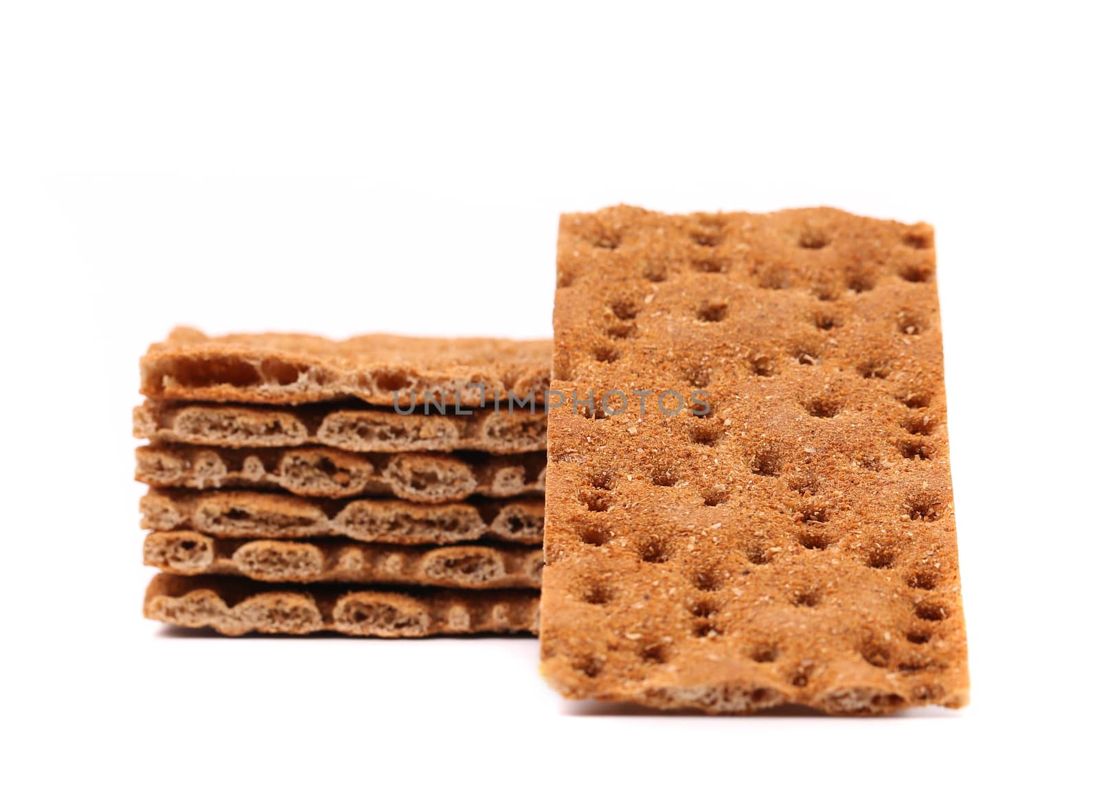 Stack of whole grain crisp bread isolated on a white background