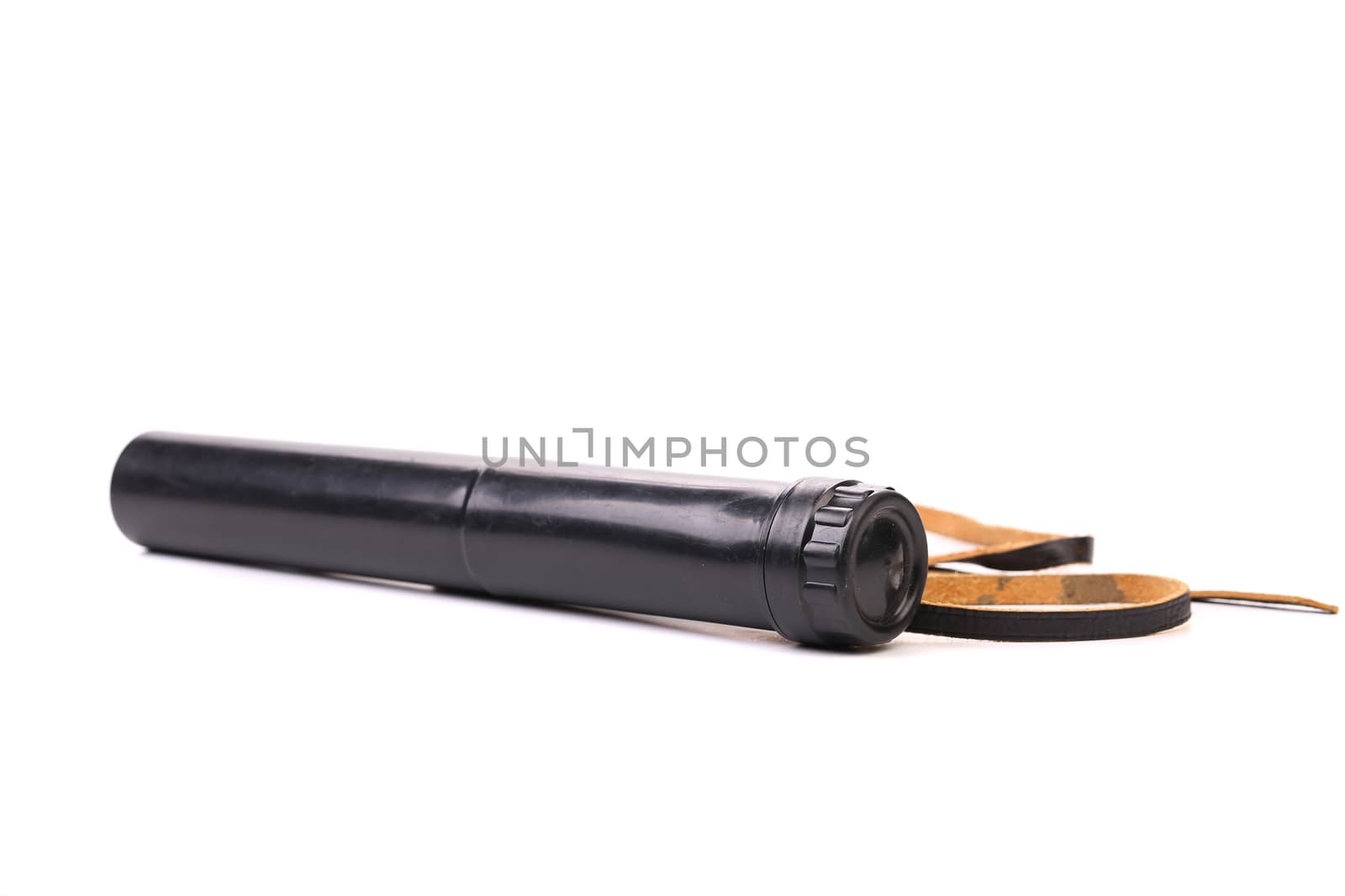 Black cover of spyglass lying on a white background