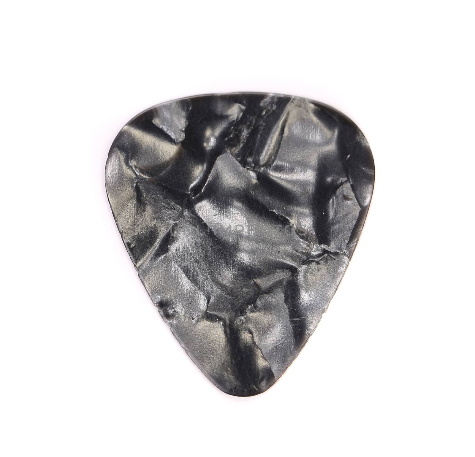 Dark plastic guitar plectrum, isolated on white